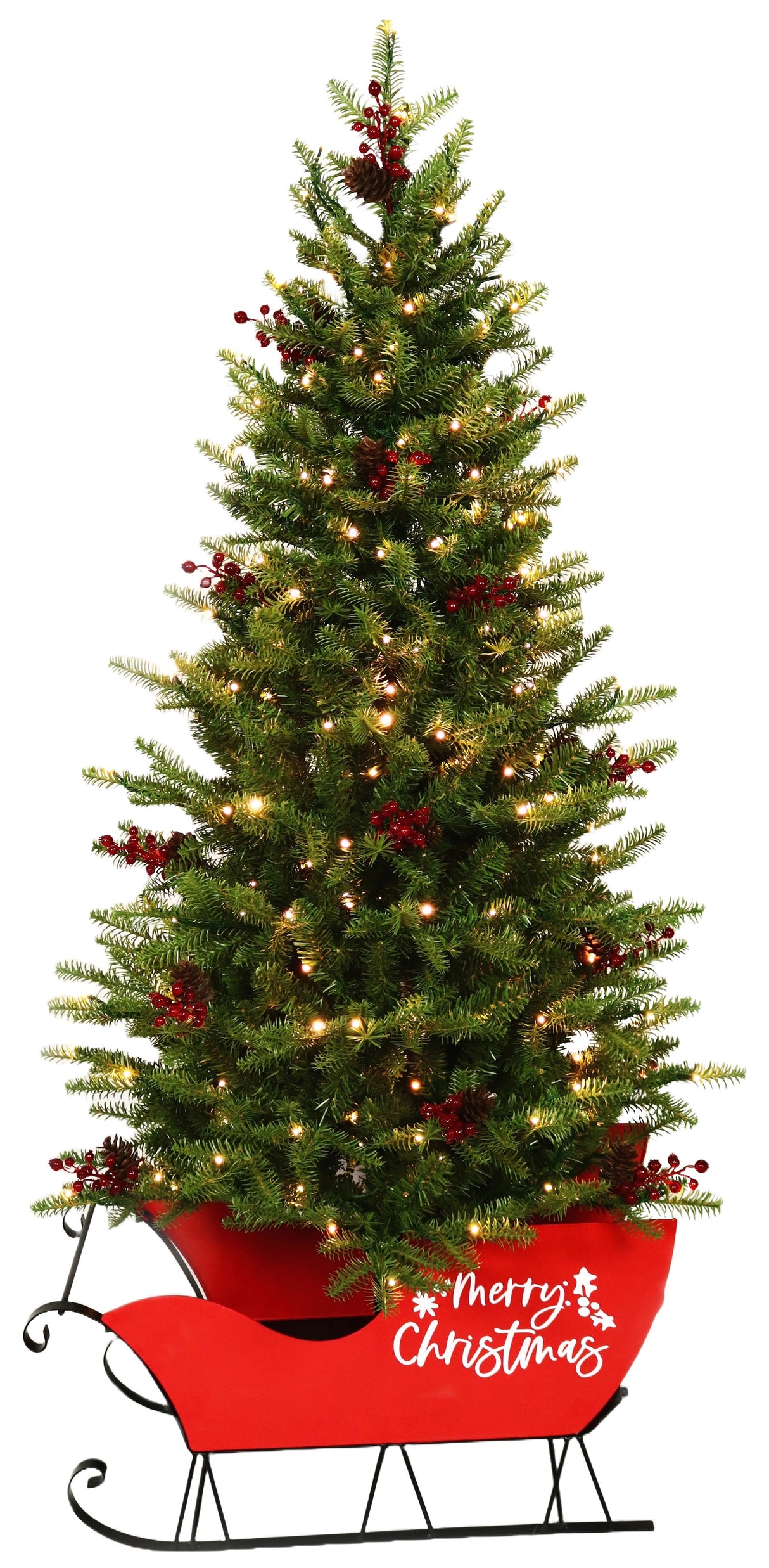 Pre-lit artificial tree in a red sleigh. The branches feature red berries and the red sleigh reads "Merry Christmas" in white, cursive font.