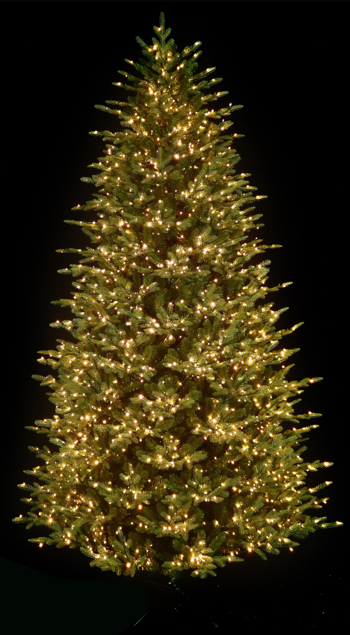 Artificial Christmas tree pre-lit with color-changing LED lights.