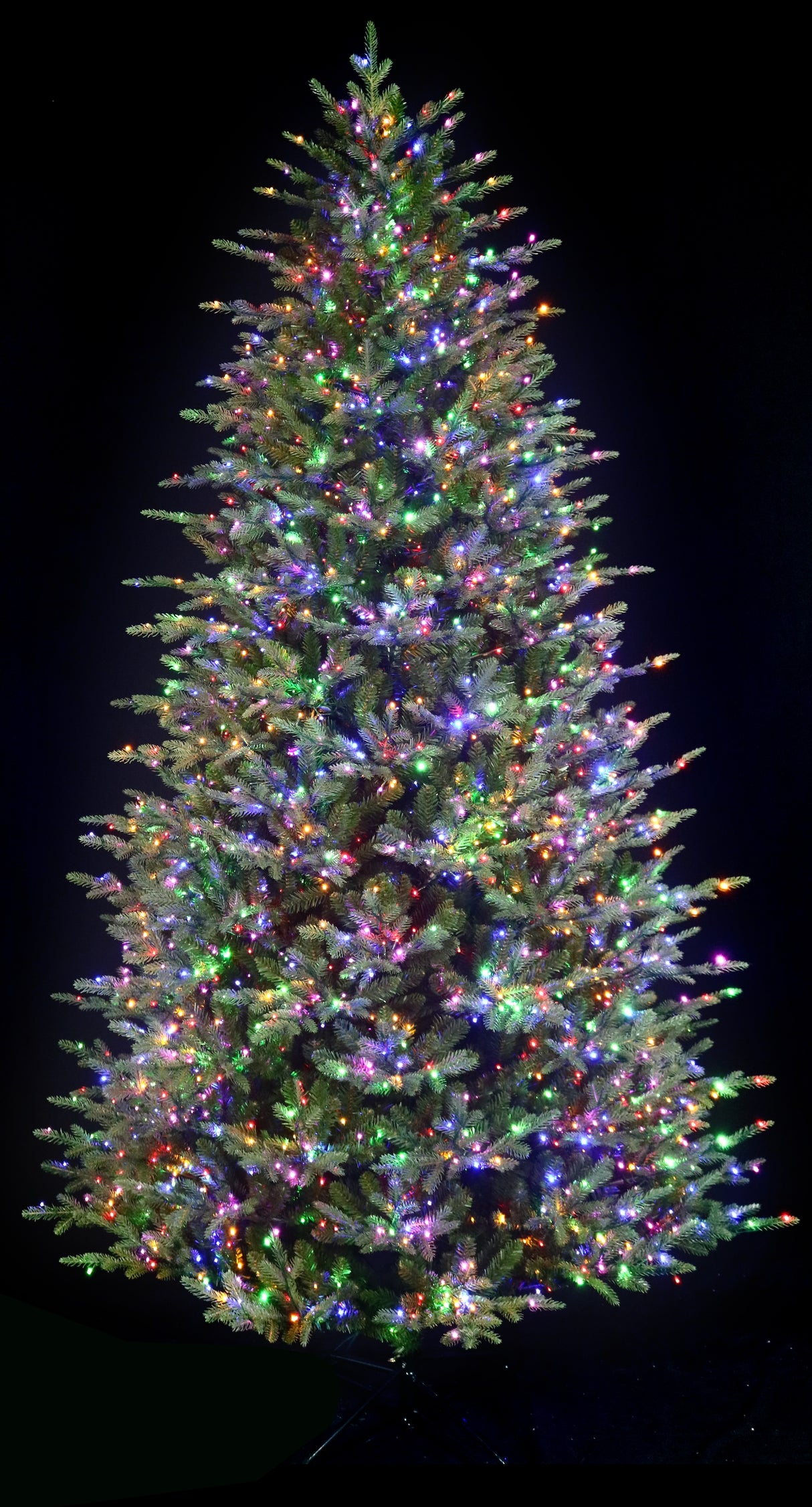 Artificial Christmas tree pre-lit with color-changing LED lights.