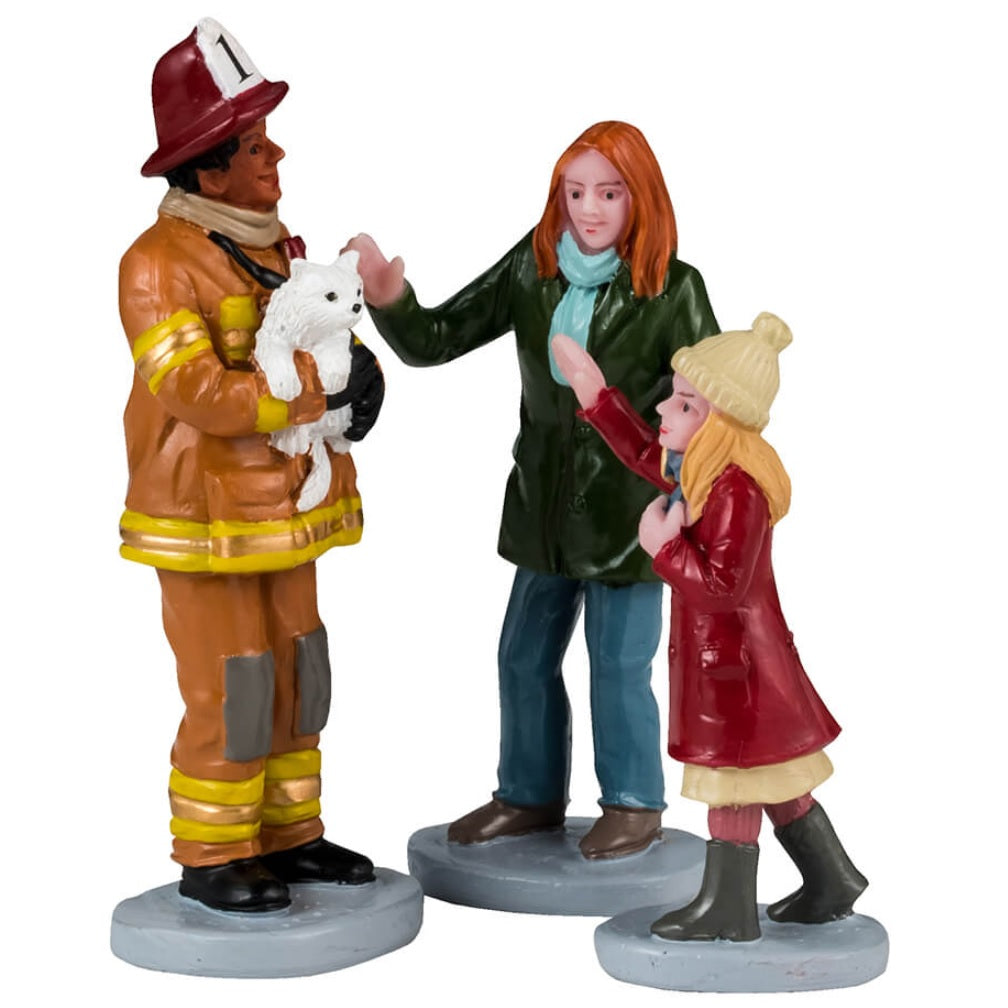 Resin figurines for a Lemax display. Designed to look like a firefighter carrying a white kitten to a woman and a young girl. The mom and the daughter are both wearing winter clothes.