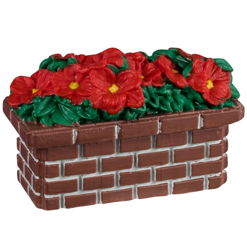 Resin village accessory for a Lemax display. Designed to look like a rectangular brick planter with red poinsettia flowers inside.