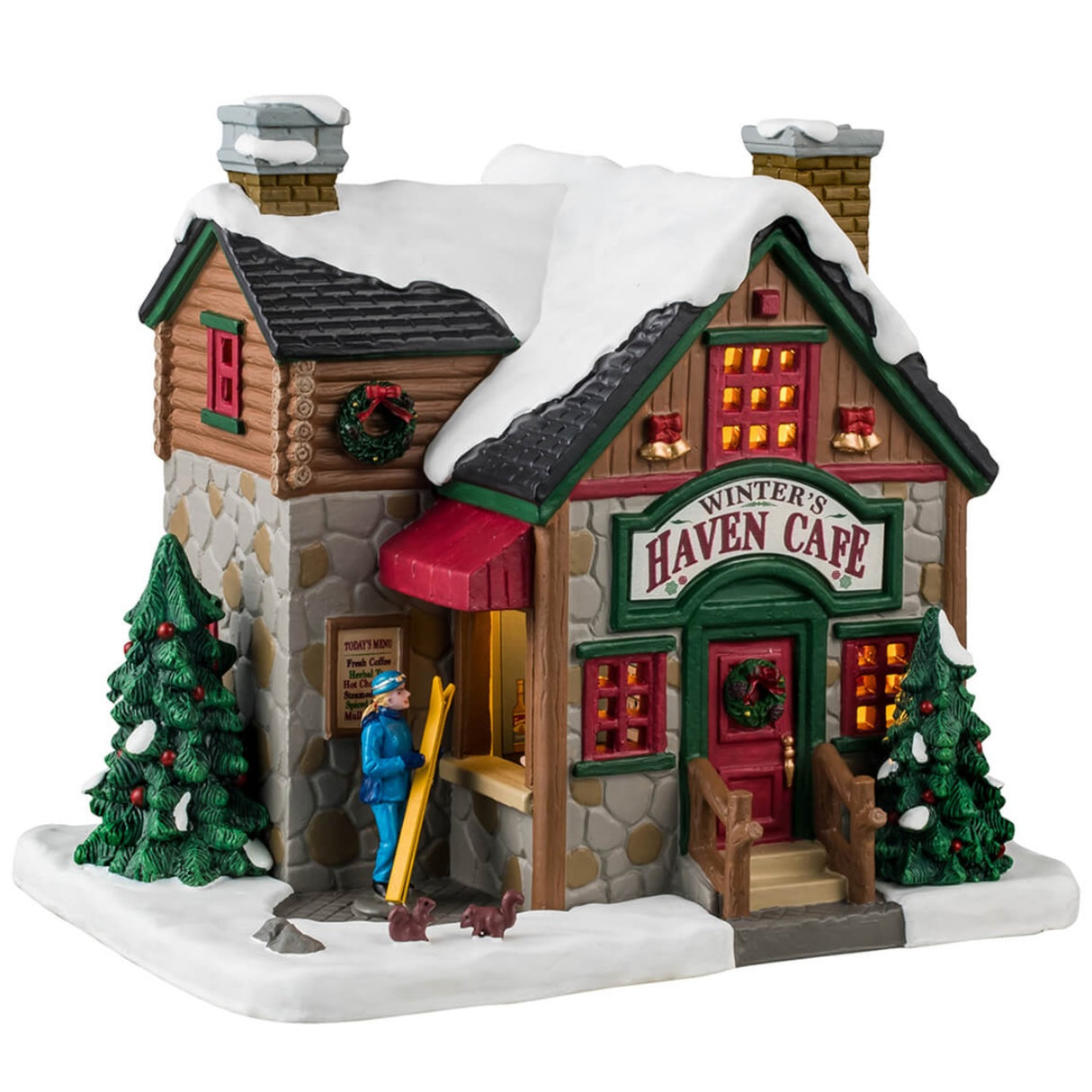 Porcelain lighted building for a Lemax display. Designed to look like a log cabin with stone accents. There's snow on the roof and wreath accents. The sign at the front door reads "Winter's Haven Care." There's a booth where a woman is checking out some skis next to a group of squirrels who are playing in the snow.