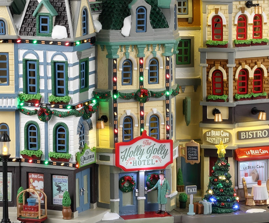 Resin lighted building for a Lemax display. Designed to look like a bunch of storefronts decorated for Christmas. There's a hotel, a cafe and a bistro.