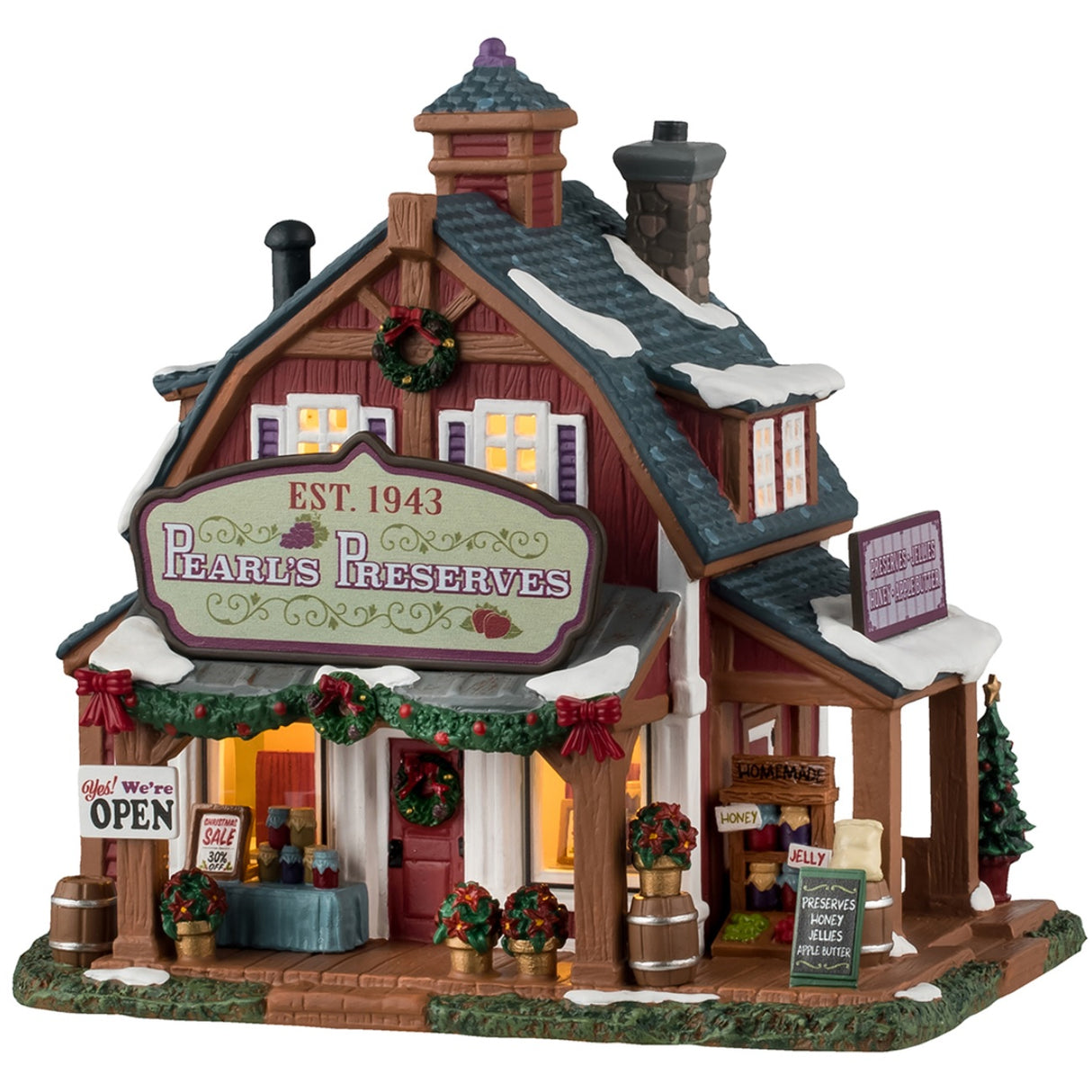 Porcelain lighted building for a Lemax display. Designed to look like a cabin with snow on the roof. There are decorated garlands and wreaths and red ribbons and poinsettias everywhere. There are signs that read: "Yes! We're open," "Christmas Sale 30% off," "Homemade honey and jelly" and "Preserves: Honey, Jellies, Apple Butter."