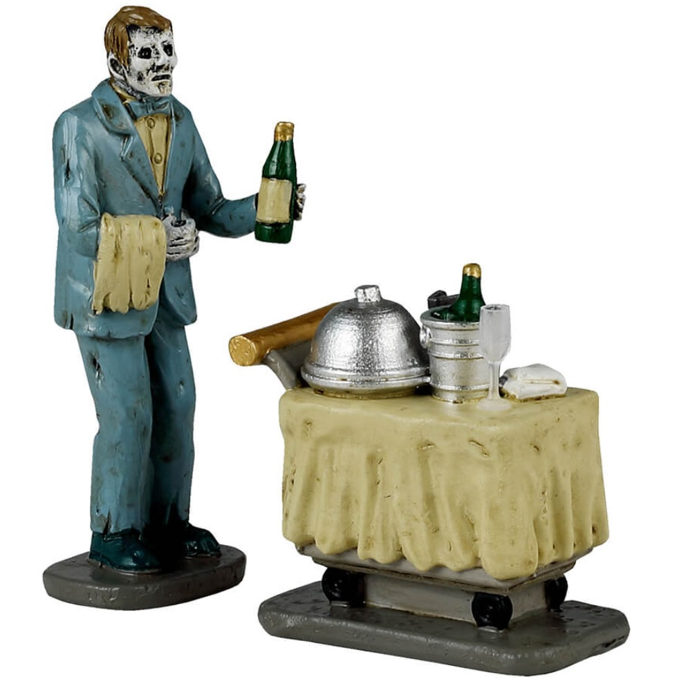 Resin figurine for a Lemax display. Designed to look like a monster bringing room service. He's wearing a blue suit and holding a bottle of wine. The cart has a yellow tablecloth over it.