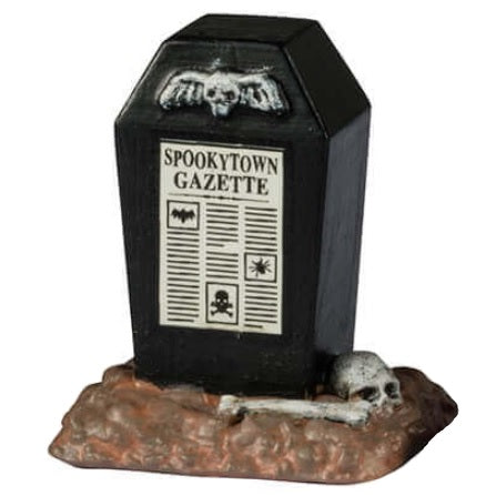 Resin village accents for a Lemax display. Designed to look like public newspaper boxes. One is orange and reads "Midnight Edition" and has a vulture sitting on top. The next one is black and shaped like a coffin. One is purple and a dark green and shaped like a birdhouse. The last one is shaped like Frankenstein's head.