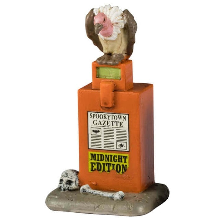 Resin village accents for a Lemax display. Designed to look like public newspaper boxes. One is orange and reads "Midnight Edition" and has a vulture sitting on top. The next one is black and shaped like a coffin. One is purple and a dark green and shaped like a birdhouse. The last one is shaped like Frankenstein's head.