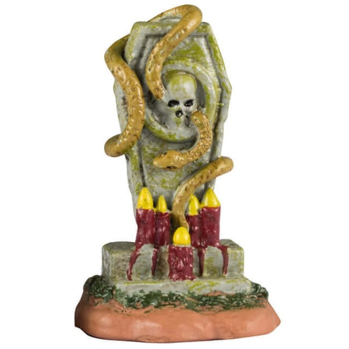 Resin village accents for a Lemax display. Designed to look like three headstones. One has a bat statue on it and it reads "Vlad Vampyr 1452-?" The next one is shaped like a cat and reads "RIP Miss Kitty aka Crazy Cat Lady." There are black cats on it. The next one features a skull with snakes coming out of it and a bunch of red candles lit at the base.