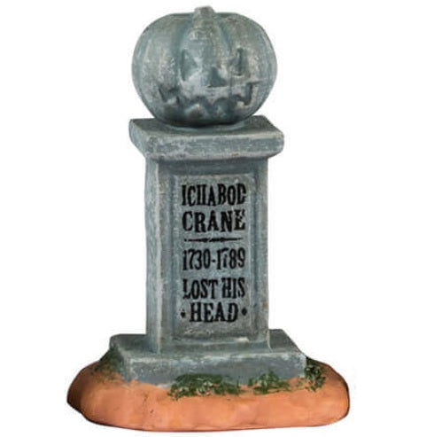 Resin village accents for a Lemax display. Designed to look like three tombstones. One is shaped like a shark and reads "Captain Jack 1957-1978." One is shaped like a pumpkin and reads "Ichabod Crane 1730-1789. Lost his head." The other is shaped like a Ouija board with a witch hat on top and has a black cat sitting on it.