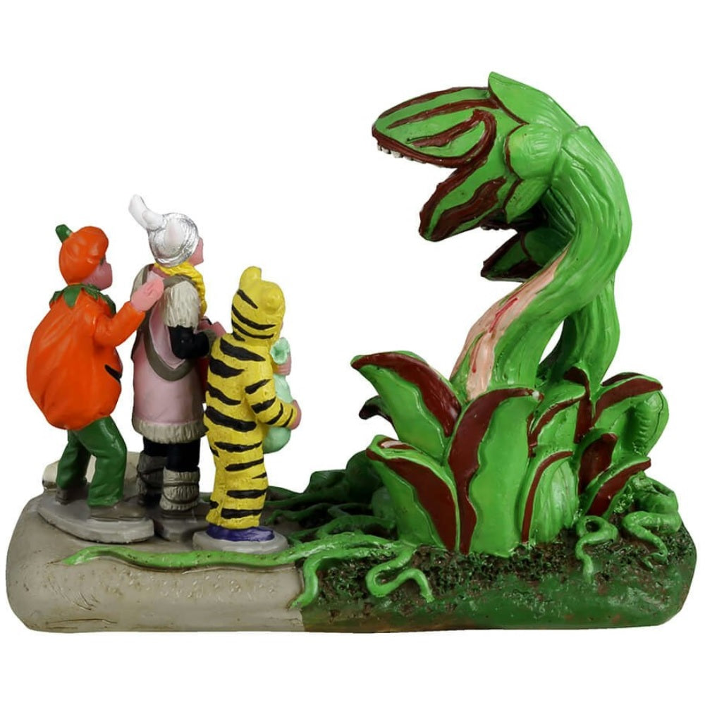 Resin figurine for a Lemax display. Designed to look like three trick or treaters getting scared by Venus fly traps that have come to life. One is dressed as a tiger, one is dressed as a Viking and the other is dressed as a pumpkin.