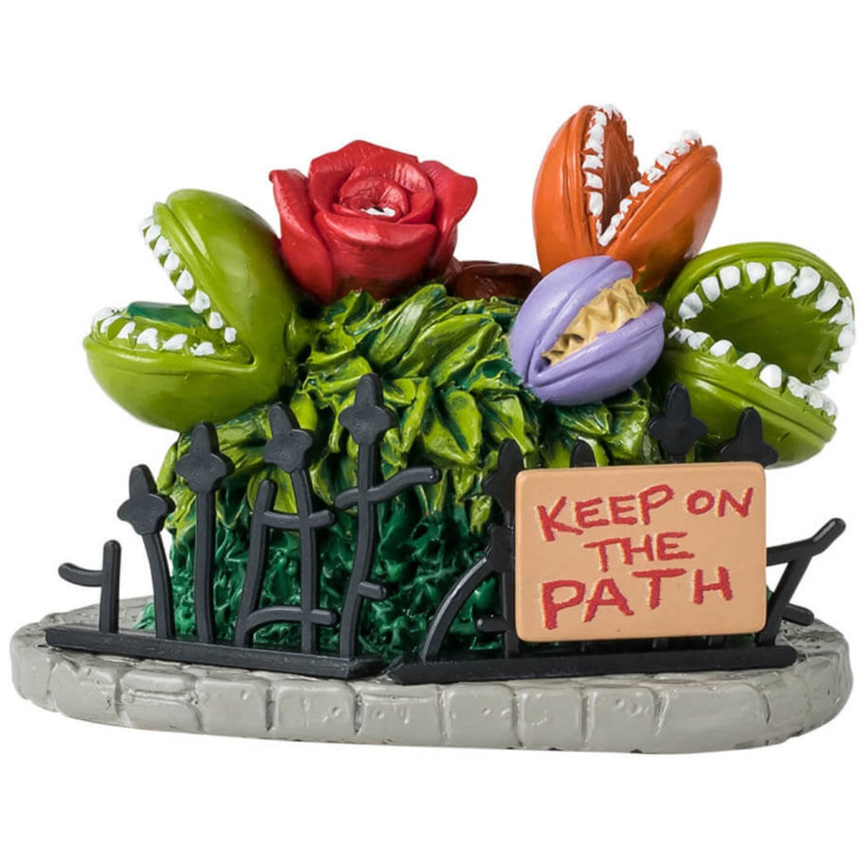 Resin village accessory for a Spooky Town Lemax display. Designed to look like a garden full of Venus fly traps with human teeth. They're green, red, orange and purple. There's a metal fence around them with a sign that reads "KEEP ON THE PATH."