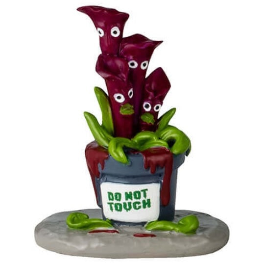 Resin table accents for a Lemax display. Designed to look like five really weird, alive plants. One looks like a bunch of green snakes coming out of a pumpkin. One is purple flowers with eyes and blue flowers in a black pot with blood coming out of it. One is red flowers with eyes and the pot reads "Do Not Touch." One is a Venus fly trap and the pot reads "Beware." The other is a purple Venus fly trap and the pot reads "Keep Back 10 feet."