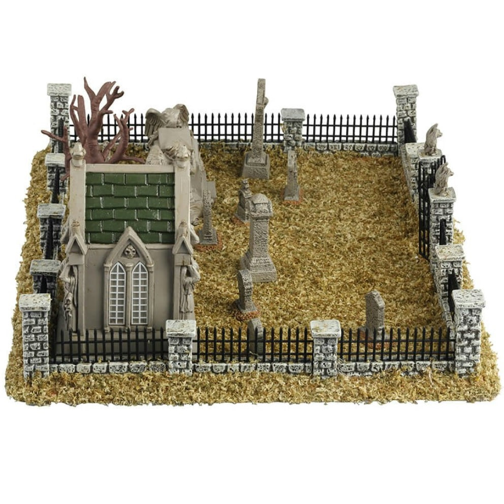 Resin village accent for a Lemax display. Designed to look like a graveyard full of dead grass. There are tombstones and headstones and mausoleums. There's also a bare tree and a metal fence with stone columns.