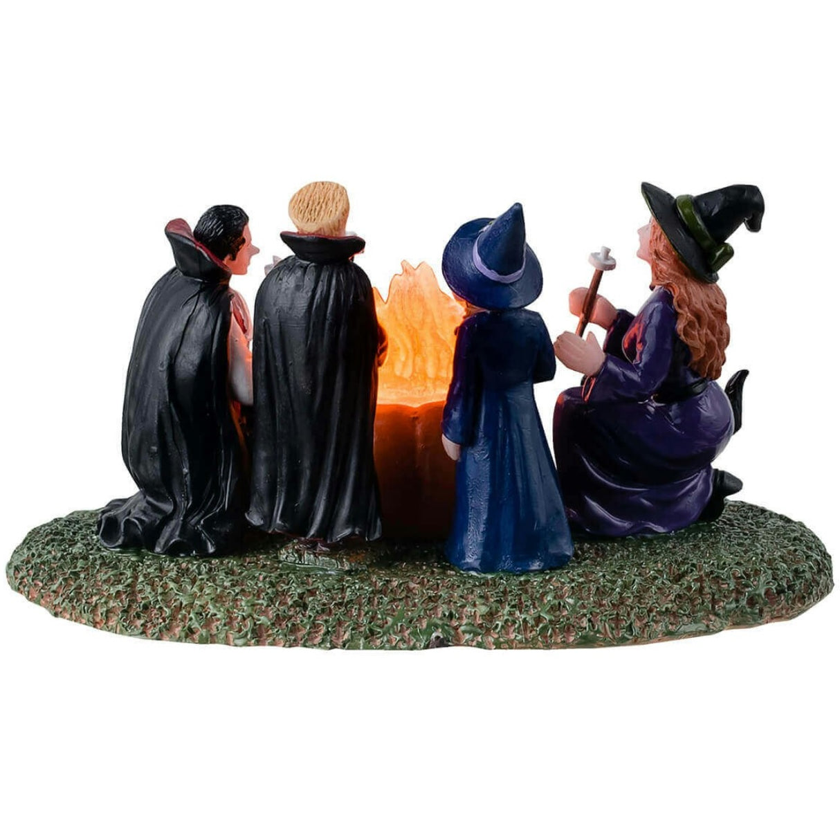 Resin table accent for a Lemax display. Designed to look like four kids dressed in costumes sitting around a fire roasting marshmallows. Two of the kids are dressed like witches and the other two are dressed like vampires. There are black cats and rats watching.