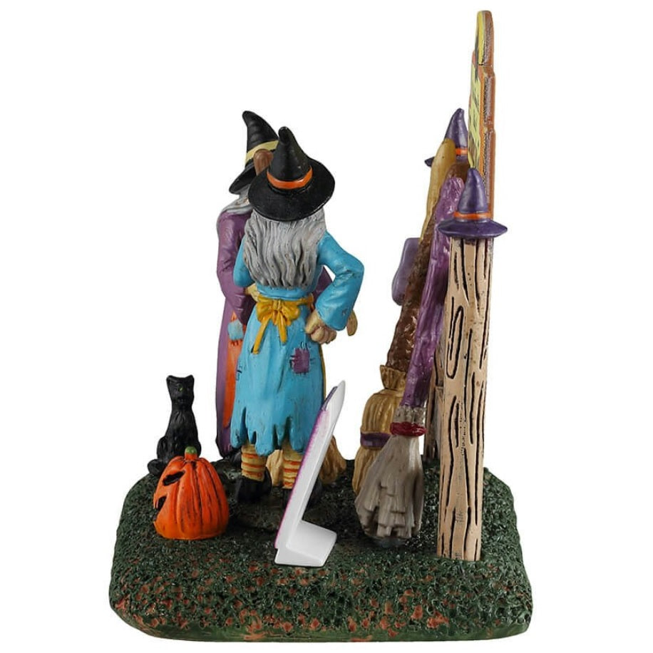 Resin table accent for a Lemax display. Designed to look like two witches storing their brooms at the broom rental spot.