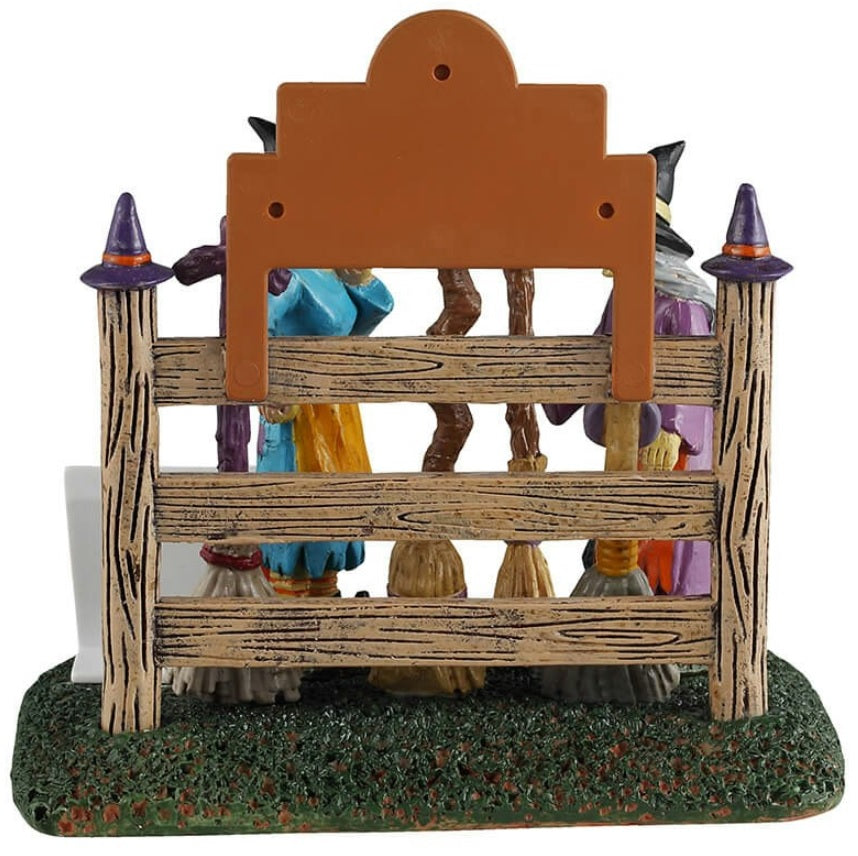 Resin table accent for a Lemax display. Designed to look like two witches storing their brooms at the broom rental spot.