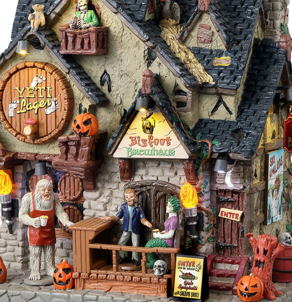 Resin lighted building for a Spooky Town display. Designed to look like a brewery with pumpkin accents everywhere. There are monsters all over, drinking.