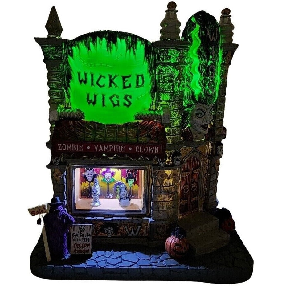 Resin lighted building for a Lemax display. Designed to look like a gothic wig store. The sign reads "WICKED WIGS" and looks like the top of Frankenstein's head. There's also a statue of the Bride of Frankenstein. There are skulls and pumpkins and cousin IT standing outside. They sell zombie wigs, vampire wigs, clown wigs and more.