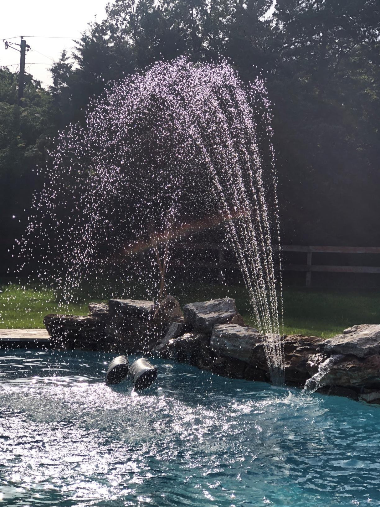 Waterfall fountain that you can add to your pool. It hooks into your pool's water return fitting. This image shows the fountain in use in an inground pool.