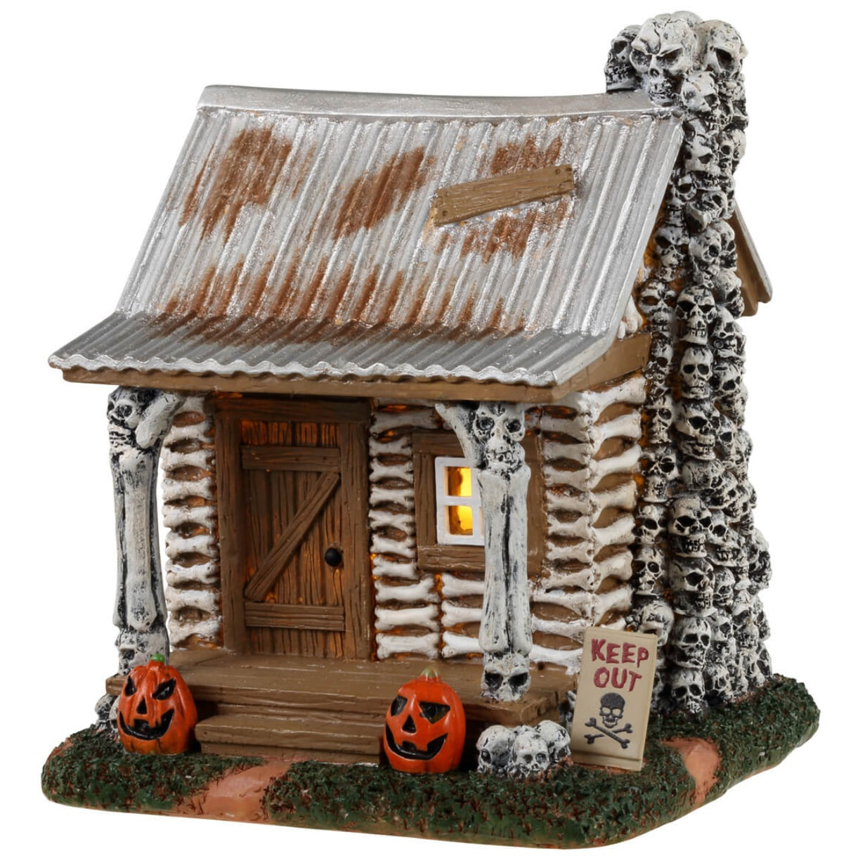 Resin village accent for a Lemax display. Designed to look like an old cabin made out of bones and skulls and wood. There are carved pumpkins on either side of the front door along with a sign that reads "KEEP OUT!"