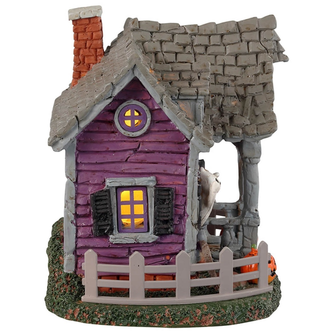 Resin village accent for a Lemax display. Designed to look like a purple, rundown house with ghosts coming out of the windows. There are jack-o-lanterns on either side of the porch and a gray fence around the house.