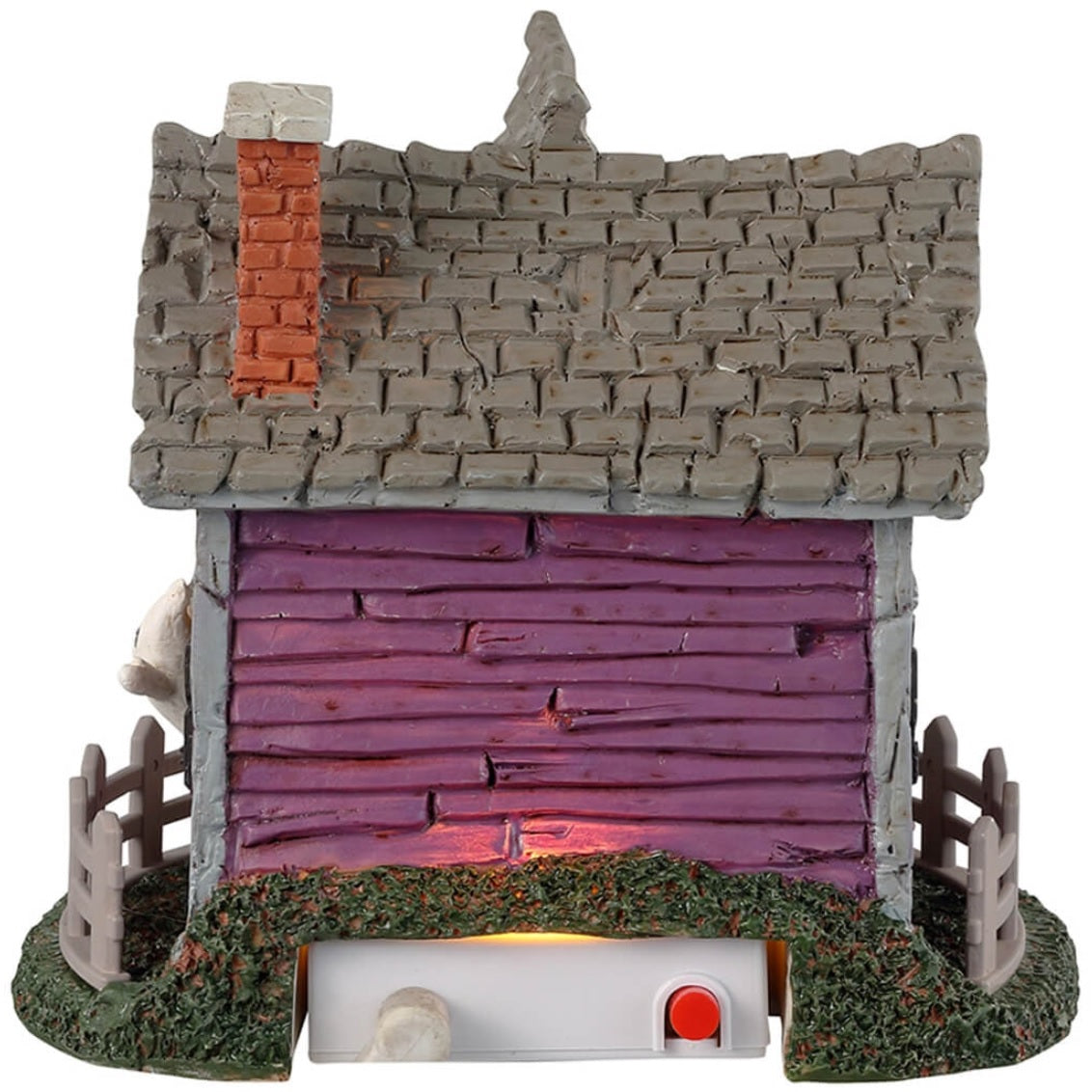 Resin village accent for a Lemax display. Designed to look like a purple, rundown house with ghosts coming out of the windows. There are jack-o-lanterns on either side of the porch and a gray fence around the house.