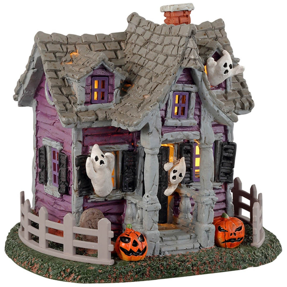 Resin village accent for a Lemax display. Designed to look like a purple, rundown house with ghosts coming out of the windows. There are jack-o-lanterns on either side of the porch and a gray fence around the house.