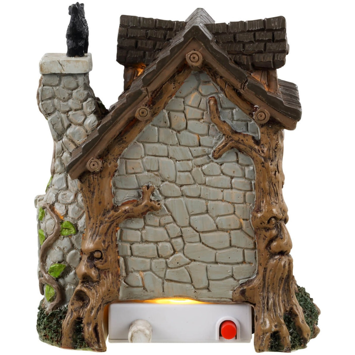 Resin table accent for a Lemax display. Designed to look like an old, stone cottage with vines growing on it. There are also trees growing into the cabin. There's a witch sweeping the front porch and a black cat standing on top of the chimney.