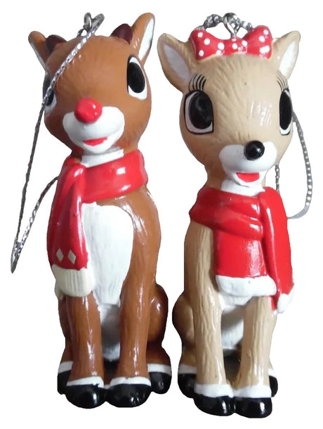 Ornaments designed to look like two of the characters from the 1964 television movie Rudolph the Red-Nosed Reindeer. One ornament is Rudolph wearing a red scarf. The other ornament is Clarice wearing a red scarf.