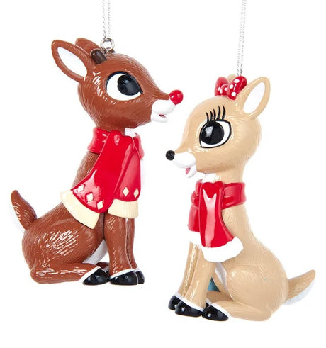Ornaments designed to look like two of the characters from the 1964 television movie Rudolph the Red-Nosed Reindeer. One ornament is Rudolph wearing a red scarf. The other ornament is Clarice wearing a red scarf.
