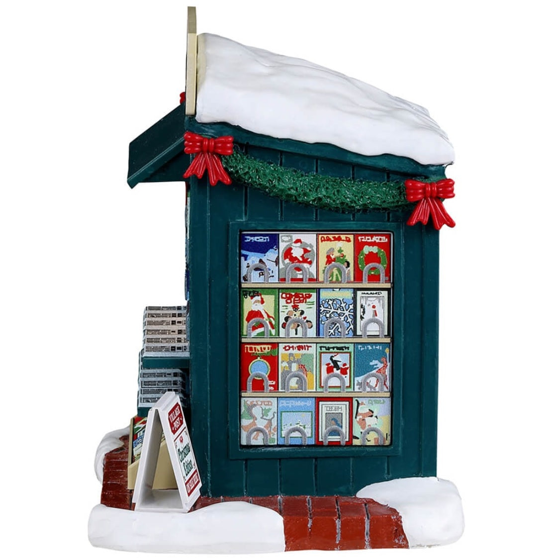 Resin village accent for a Lemax display. Designed to look like a newspaper stand decorated for Christmas. The vendor inside is wearing a winter hat, scarf and coat and is drinking from a white cup.