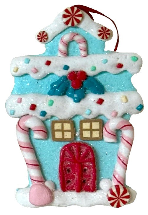 One gingerbread house is teal with a holly leaf accent. One gingerbread house is pink with a wreath accent. One gingerbread house is brown with a peppermint accent. Each ornament features faux candy canes, frosting and gum drop accents.