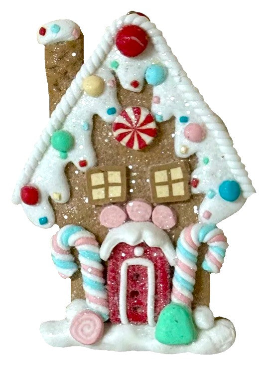 One gingerbread house is teal with a holly leaf accent. One gingerbread house is pink with a wreath accent. One gingerbread house is brown with a peppermint accent. Each ornament features faux candy canes, frosting and gum drop accents.