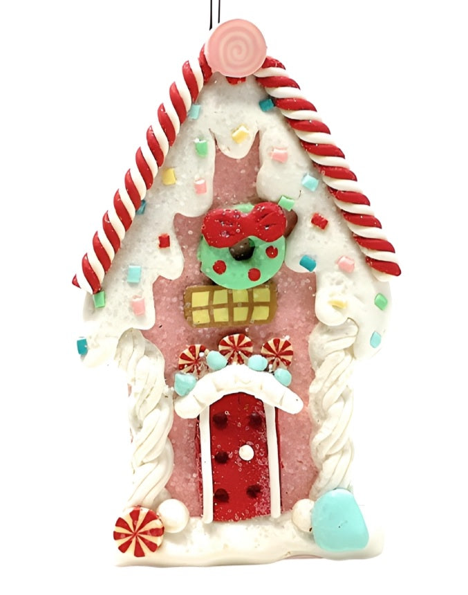 One gingerbread house is teal with a holly leaf accent. One gingerbread house is pink with a wreath accent. One gingerbread house is brown with a peppermint accent. Each ornament features faux candy canes, frosting and gum drop accents.