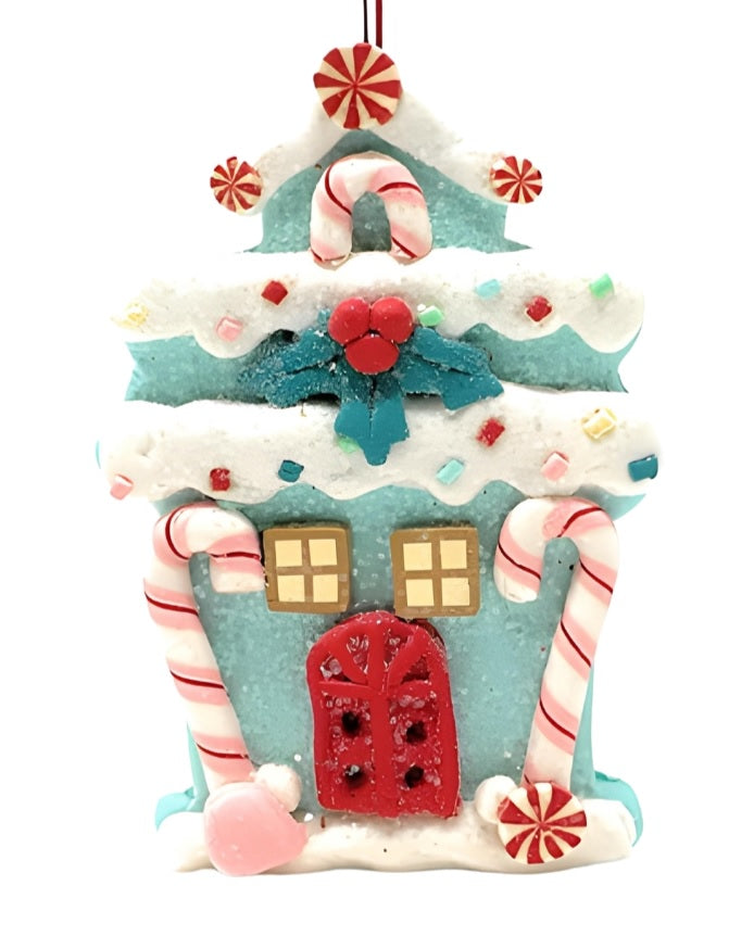 One gingerbread house is teal with a holly leaf accent. One gingerbread house is pink with a wreath accent. One gingerbread house is brown with a peppermint accent. Each ornament features faux candy canes, frosting and gum drop accents.