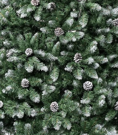Artificial tree with pine cones and white on the branch tips to look like snow.