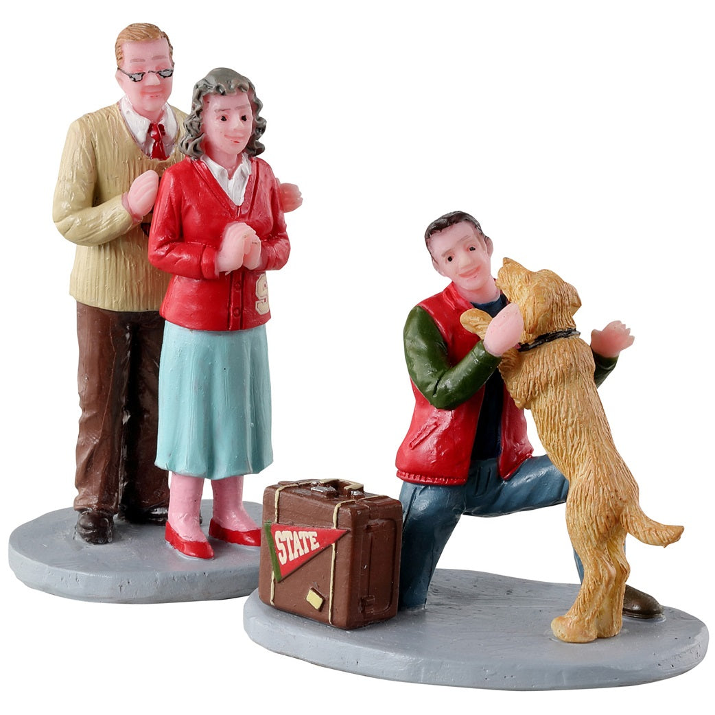 Resin figurines for a Lemax display. Designed to look like two parents excited to see their son. Their dog is also really excited to see him. The son has a suitcase next to him with a flag on it that reads "STATE."
