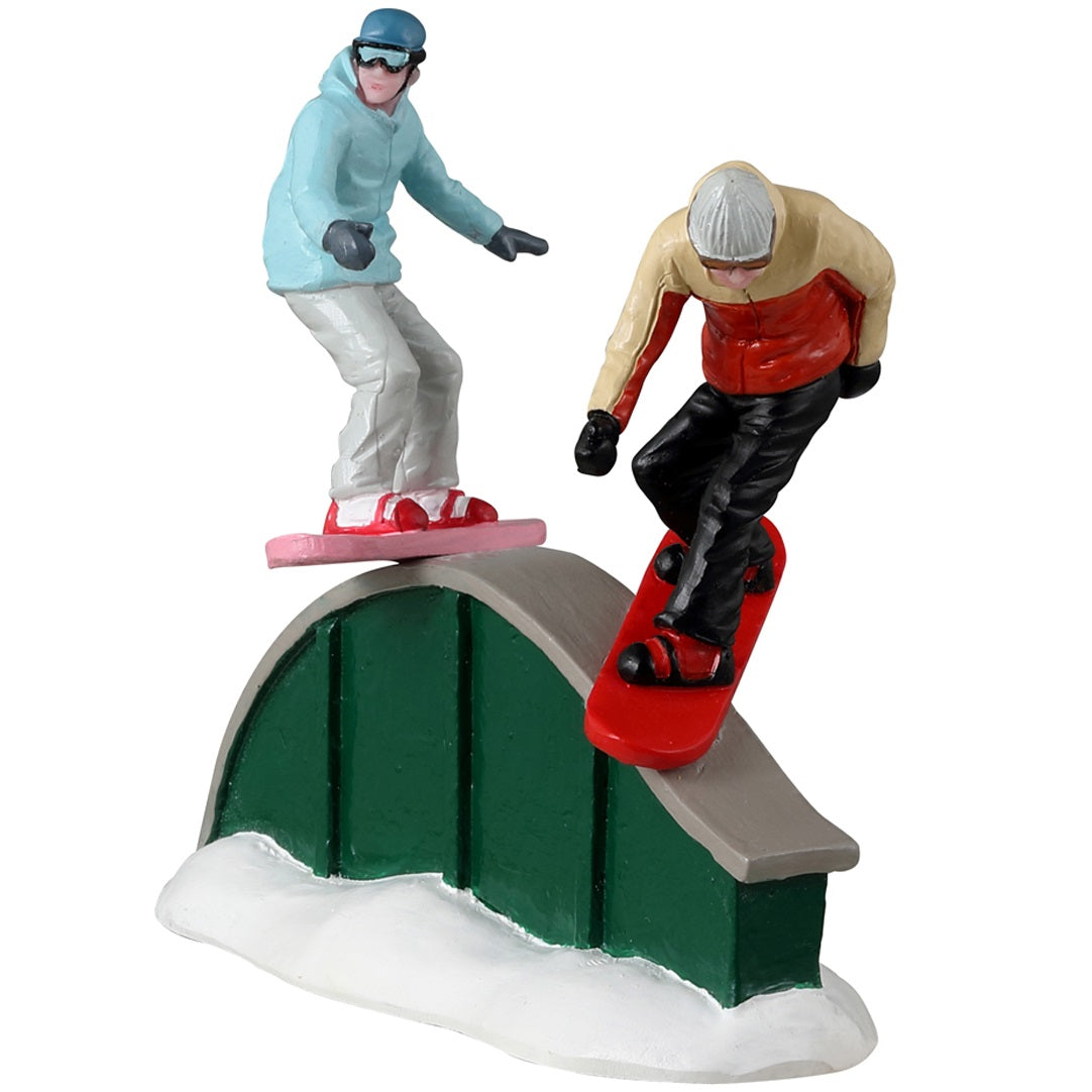 Resin figurine for a Lemax display. Designed to look like two people snowboarding on a rail.