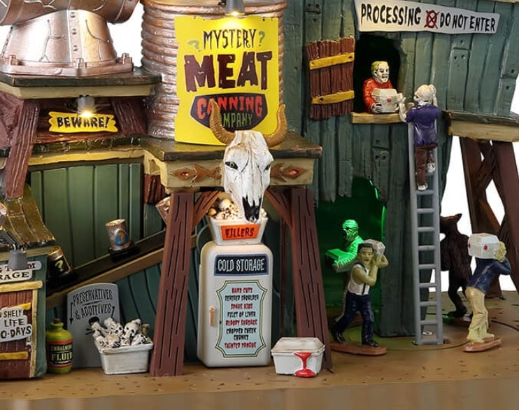 Resin building for a Lemax display. Designed to look like a really weird meat packing plant. There are crows flying above. There's a large statue of a brain going into a meat grinder on the roof. There are monsters working.