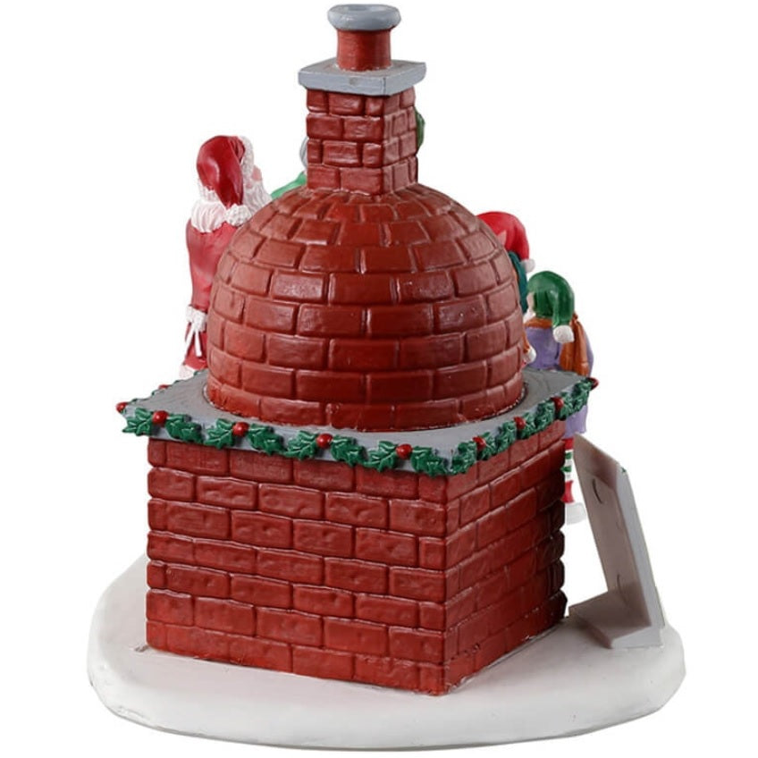 Resin village accent for a Lemax display. Designed to look like Santa and Mrs. Claus cooking gingerbread in a wood-fired oven. There are three elves helping.