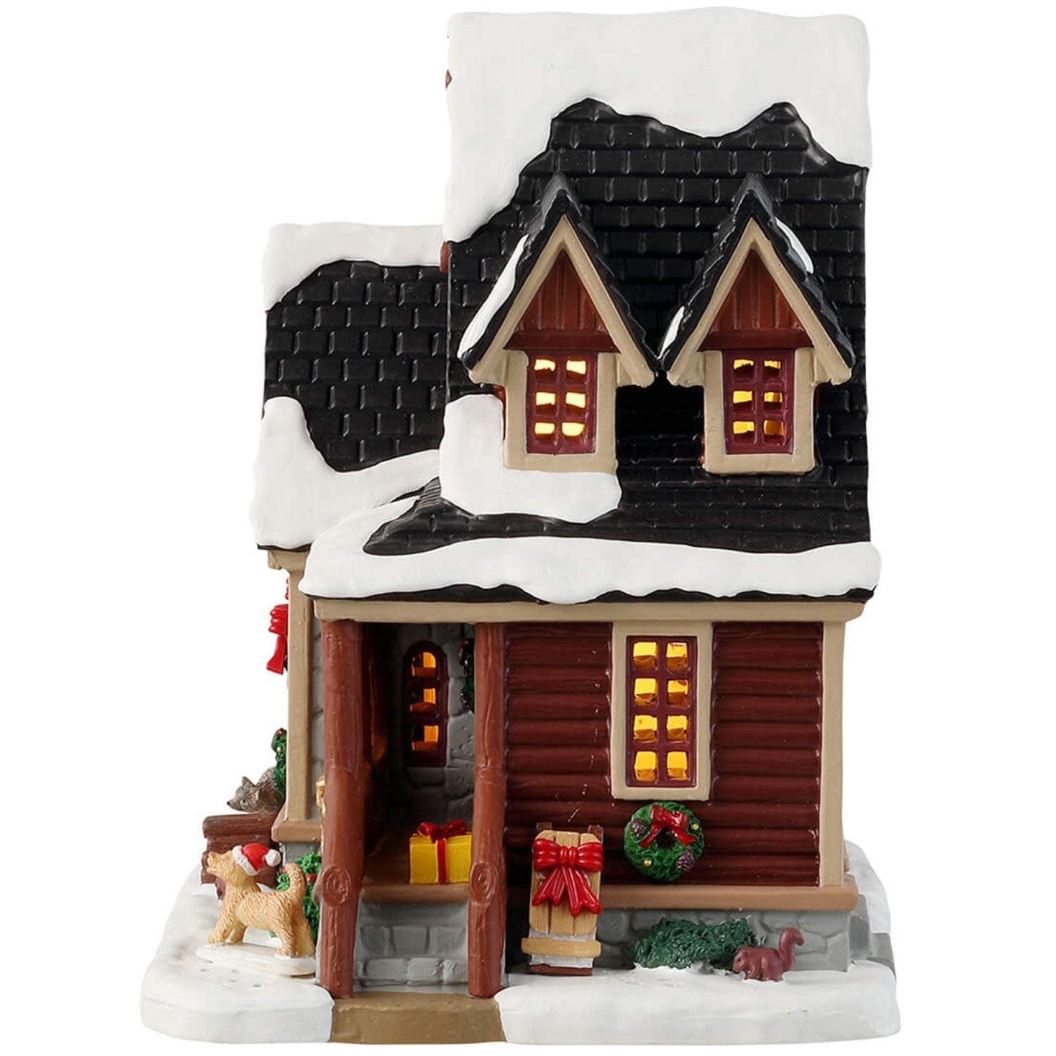 Porcelain lighted building for a Lemax display. Designed to look like a snow-covered log cabin. There are decorated wreaths, garland and Christmas trees. There's also a dog wearing a Santa hat near the front porch.