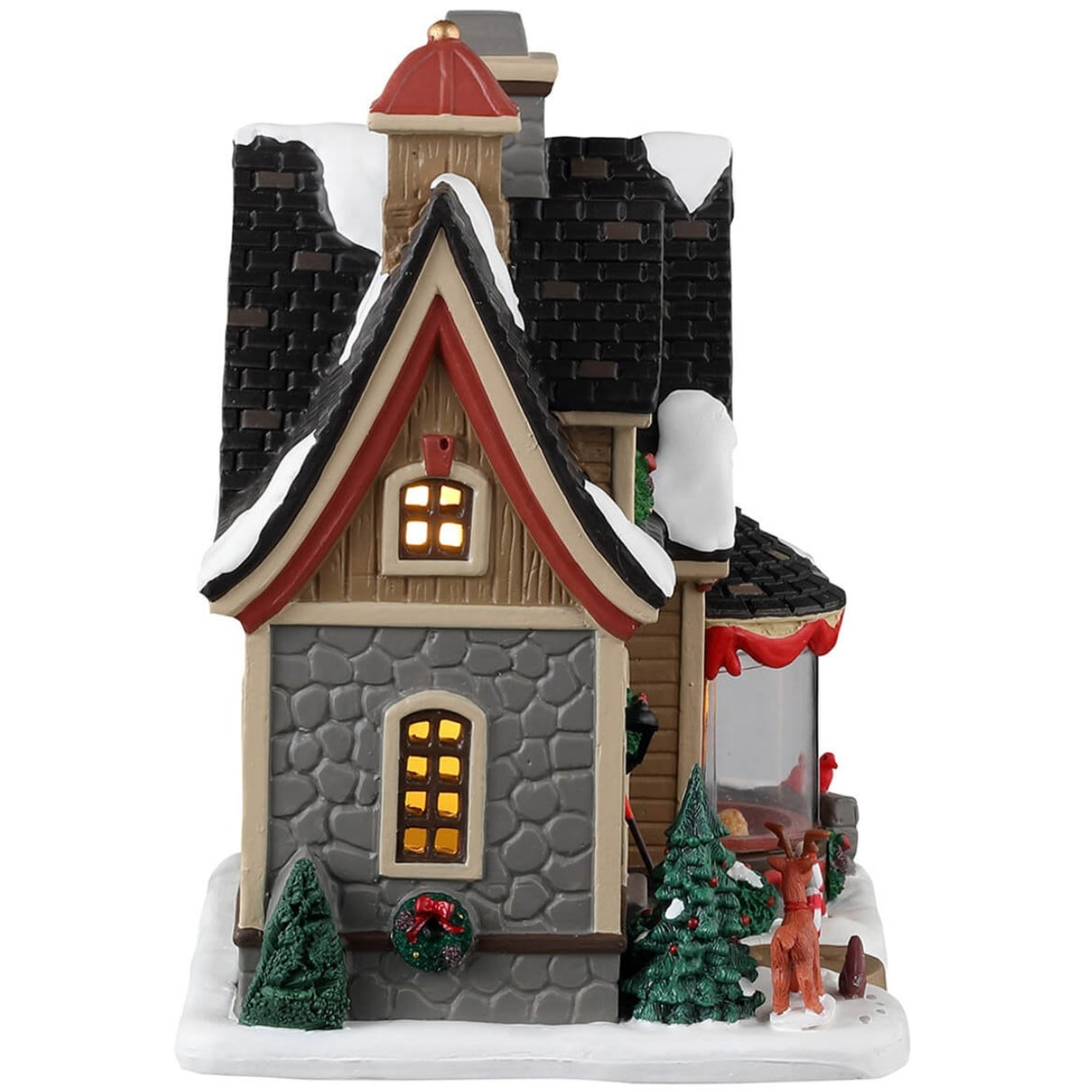 Porcelain lighted building for a Lemax display. Designed to look like a cute home decorated for Christmas. There's snow on the roof and on the sidewalk. There are wreaths, red ribbons and candy cane accents. There's a reindeer and a squirrel near the front door. In the window, you can see a couple relaxing near a fireplace.