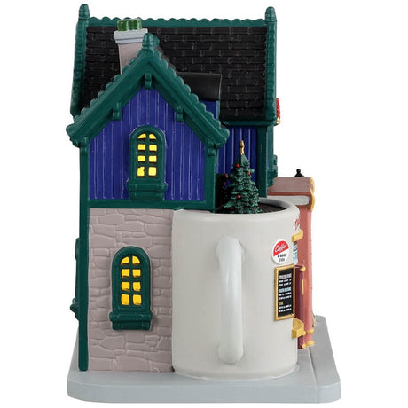 Porcelain lighted building for a Lemax display. Designed to look like a blue book store that also sells coffee. The front door's frame is made to look like it's made out of books. The booth to the right looks like it's made out of a white mug. The building is decorated for Christmas.