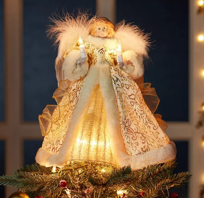 This is a lifestyle image showing the angel on top of a tree.