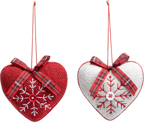 Heart-shaped Christmas ornament. One ornament is red with a white snowflake in the center. One ornament is white with a red snowflake in the center.