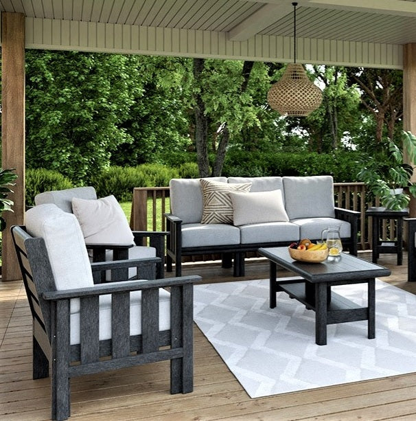 Black resin patio furniture with gray cushions on a porch