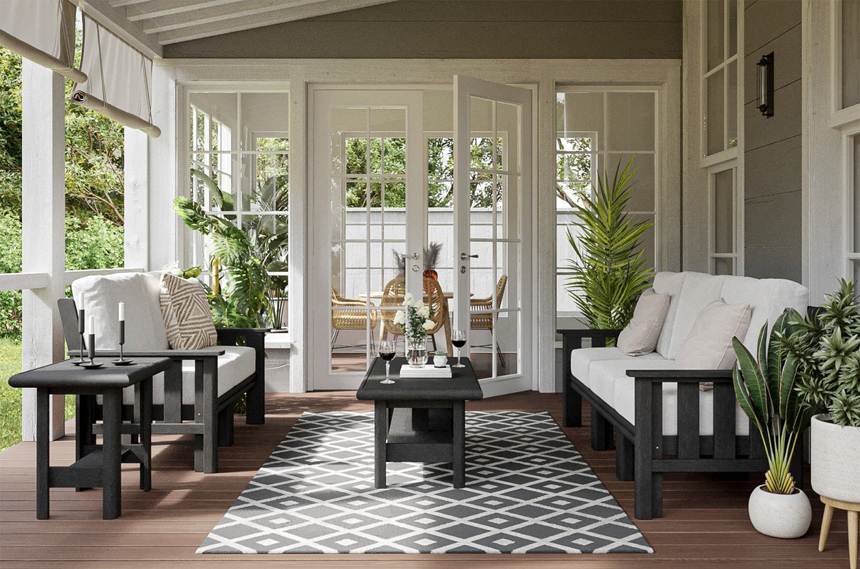 Black frame patio furniture with white cushions on an outdoor patio