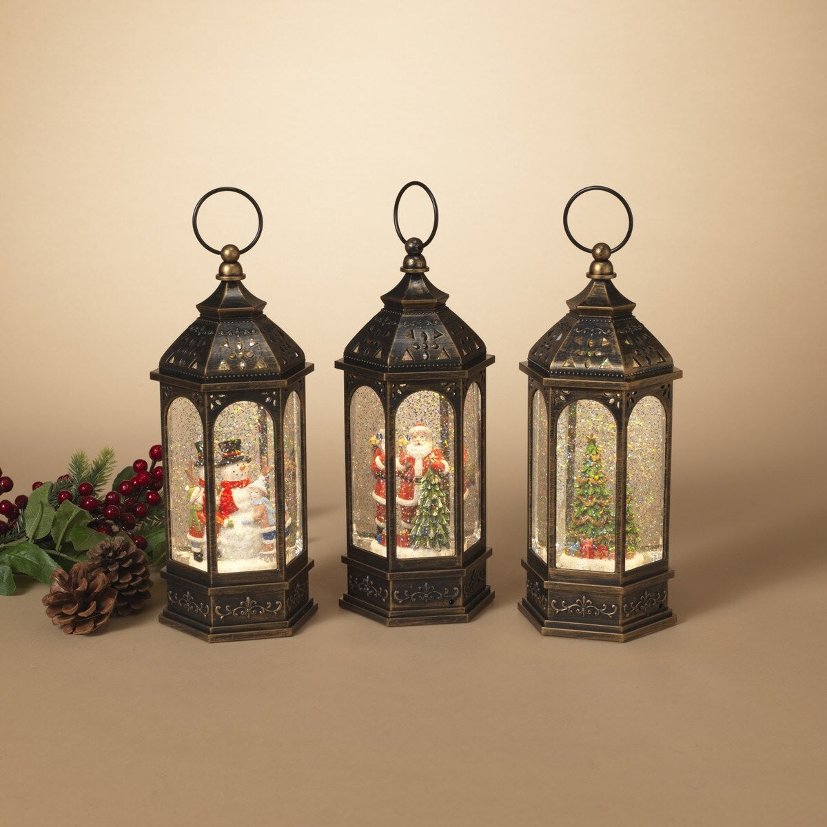 Bronze lanterns with snow globe inside. One lantern features a snowman with two kids. One lantern features Santa with a tree. One lantern features a decorated tree with presents underneath. There's swirling glitter and lights inside.