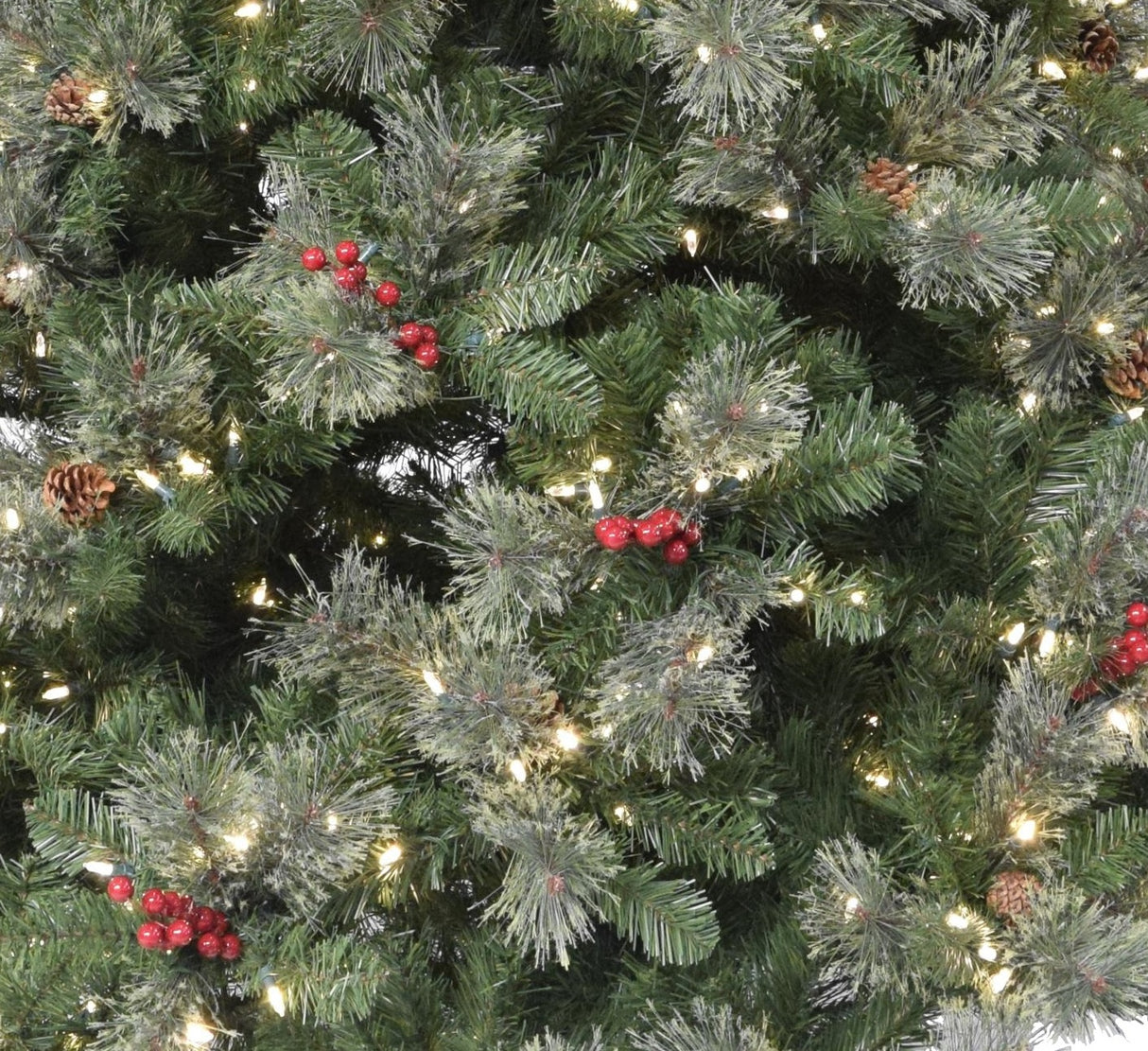 Artificial tree pre-lit with dual lights. Lights change from clear to multi-colored. The tree is decorated with red berries and white glitter.