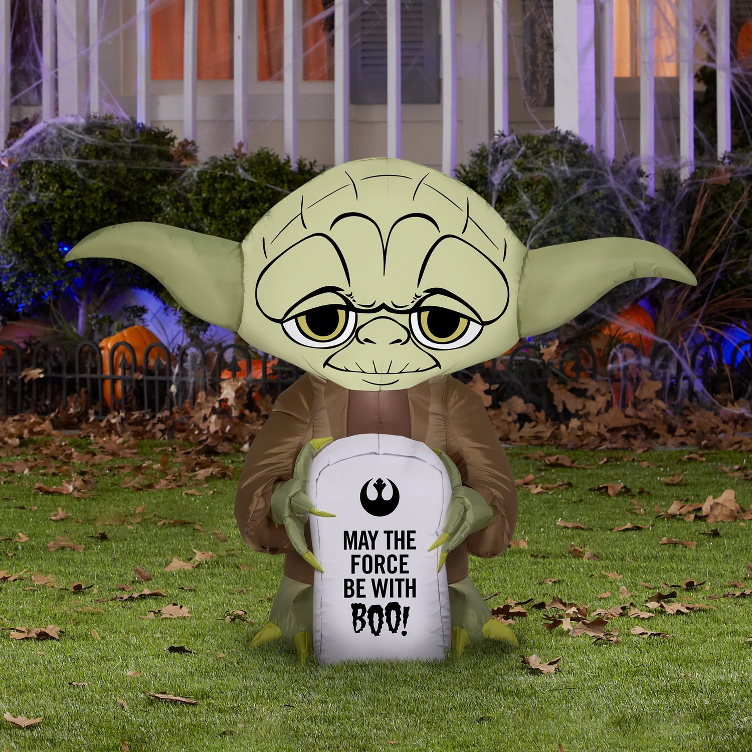Halloween inflatable shaped like Yoda from Star Wars holding a tombstone that reads "MAY THE FORCE BE WITH BOO!" The tombstone also features the Rebel Alliance Starbird logo.